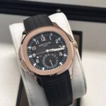 Patek Philippe Aquanaut Travel Time 5164R in rose gold with black embossed dial and rubber strap, displayed in presentation box